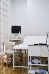Interior of hospital room with medical ultrasound diagnostic equipment and bed. Medical concept