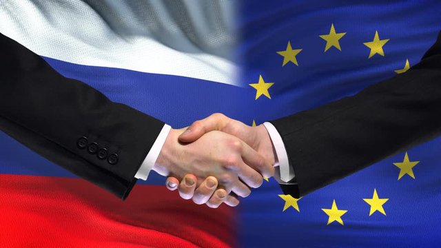 Russia and European Union handshake, international friendship, flag background