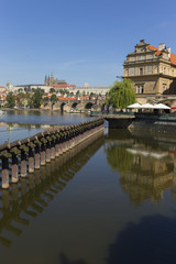 Fototapeta premium Spring Prague gothic Castle with the Lesser Town above River Vltava in the sunny Day, Czech Republic