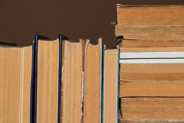 background, defocusing. Old books neatly stacked on the shelf