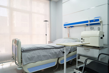 Empty Bed On Hospital Ward. Hospital room with bed and comfortable medical equipped in a modern hospital