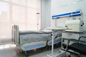 Empty Bed On Hospital Ward. Hospital room with bed and comfortable medical equipped in a modern hospital