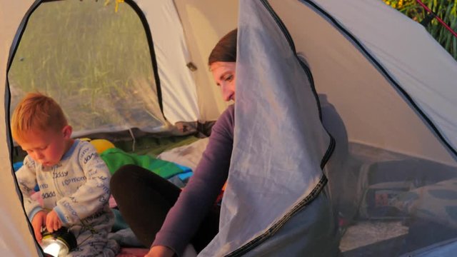 Mother and son in backpacking tent. 