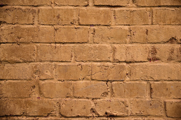 Grunge style background. Relief brick wall, mustard color