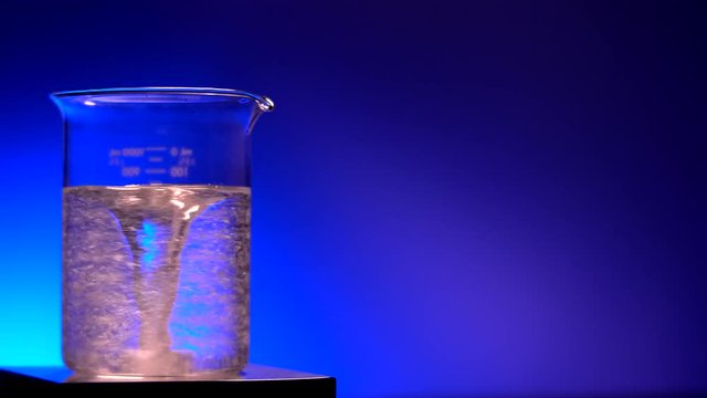 CRYSTALS BEING MIXED IN THE LAB.  4K close up with negative space.