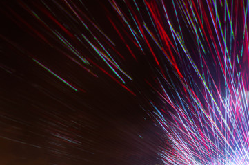 Laser disco rays on a dark background, close up