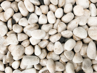 Smooth and rounded sea pebbles texture. Sea pebbles background with white and black stones