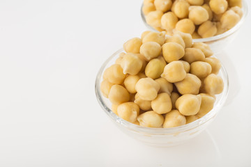 Chickpea grains (Cicer arietinum) in bowl isolated on white background