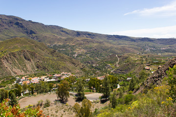 Fototapeta na wymiar Nice views of small town in valley on Gran Canaria, Spain. Nature landscape in Canary Islands. Sightseeing tour concept
