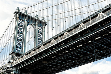 Fototapeta na wymiar Closeup isolated against blue sky view of under Manhattan Bridge in Brooklyn outside exterior outdoors in NYC New York City