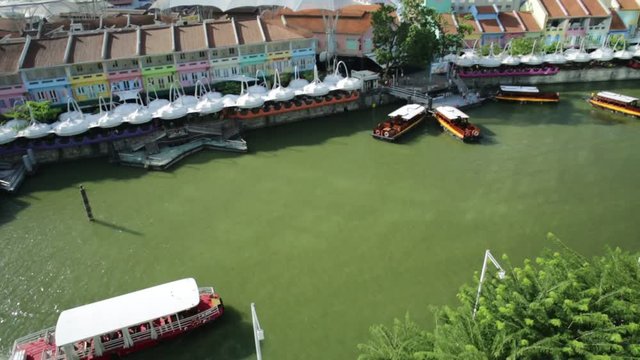 Daylight aerial view of Clarke Quay in Riverside area of Singapore, Southeast Asia. Cruise boat on Singapore River skyline in the sun.