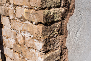 texture of battered, dirty and old brick wall and floor of various colors