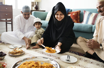 Muslim family having dinner on the floor