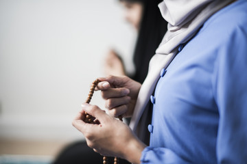 Muslim women using misbaha to keep track of counting in tasbih - obrazy, fototapety, plakaty
