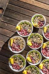 bowls with healthy breakfast food on wooden background