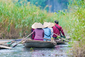 Foto op Canvas Bamboo tourist boat in tam coc caves at Natural Reserve of Van Long wetlands. Van Long Lagoon is attractive eco tourism site for tourists in Gia Vien district Ninh Binh, Vietnam © pomphotothailand