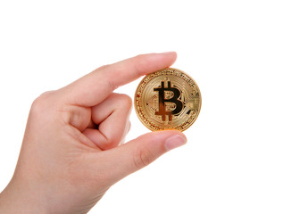Young female hand holding physical golden bit coin depecting Digital Cryptocurrency currency isolated on white background.