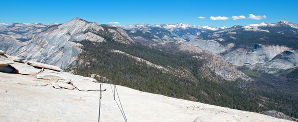 Hikers cables as seen from the top of  Half Dome in Yosemite National Park in California United States