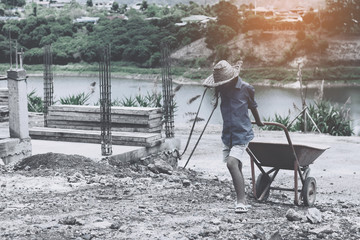 Children working at construction site for world day against children labour concept: