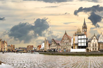 Golden sunset and dramatic clouds over historic buildings in medieval Belgian city Ghent - one of the most attractive touristic places in Europe