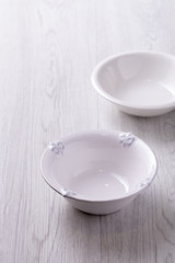 White bowl on wooden table