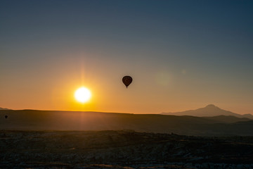 Hot air balloon, sun and Erciyes mountain