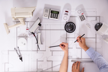 Two Architects Planning Project On Blueprint