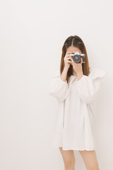 Portrait of young asian woman holding vintage camera for take a photo, Woman photographer in action on white background.