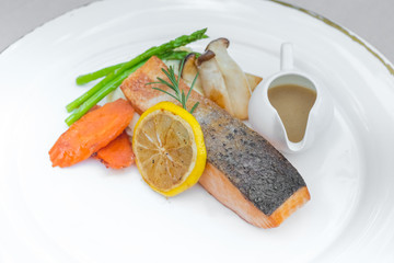 Grilled salmon steak slices on a white plate
