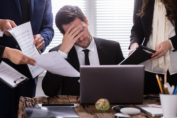 Stressed Businessman Sitting In Office - obrazy, fototapety, plakaty