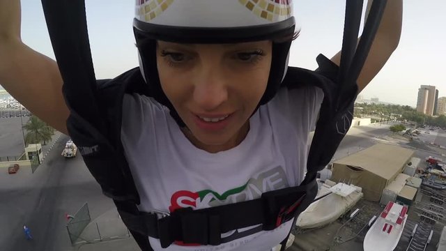 beautiful woman jumping from skybuilding and using parachute. Freedom woman extreme sport