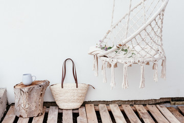 Summer hygge concept with hammock chair in the garden