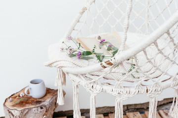 Summer hygge concept with hammock chair in the garden