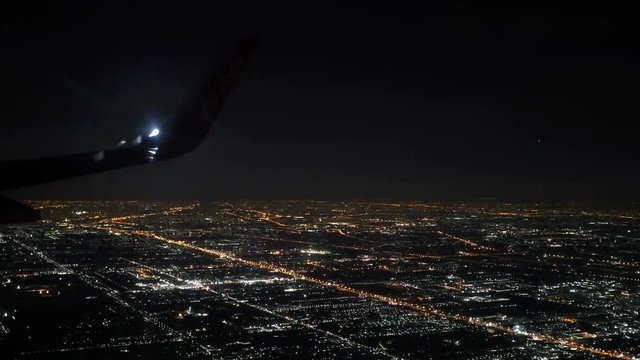 Bangkok, Thailand- Jun 4, 2018. Thai Airasia airline flight FD 3010 fly from Phuket (HKT) to Donmuang Bangkok (DMK) is landing. View from window seat Illuminated city in dark night. 
