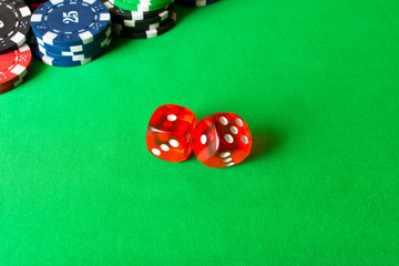 Dice, poker chips on the green table . The concept of winning . Close up