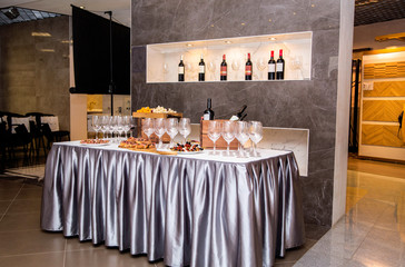 the table is covered with appetizers and glasses for wine