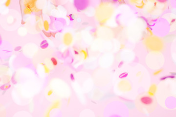 View from above on pink pastel flying confetti. Party explosion concept.