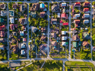 Obraz premium Fotografia lotnicza wioski wiejskiej z kolorowymi domami, dobrą drogą, zielonymi drzewami i podwórkami. Strzał z drona helikoptera