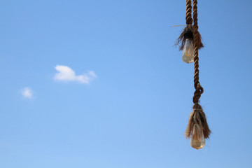 The rope and the bulb. Taken during a sunny day, with perfect blue sky in Bali,