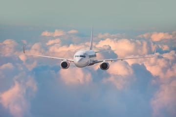 White passenger airplane in the clouds. travel by air transport