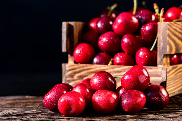 Fresh sweet cherries in a wooden box close