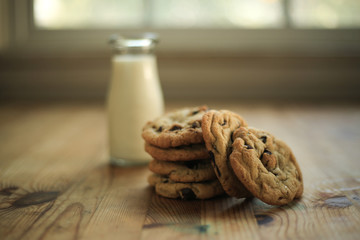 leaning tower of chocolate chip cookies with milk bottle