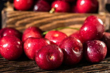 Fresh sweet cherries in a wooden box close
