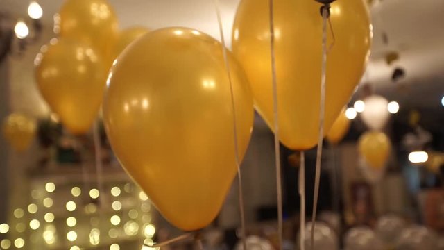 Golden ballons on the ceiling at the party. beatiful warm colors