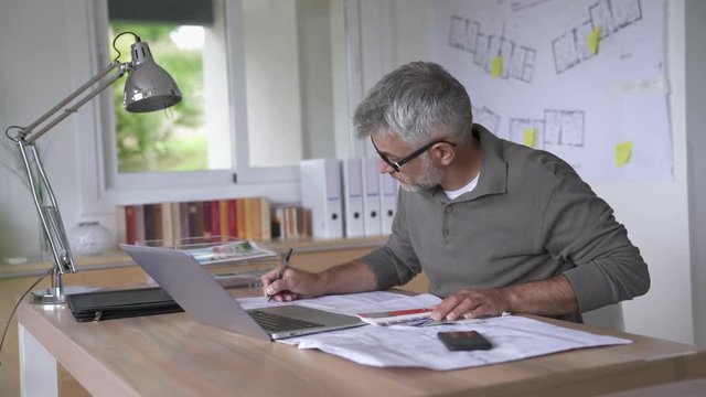  Designer in office working on project                            