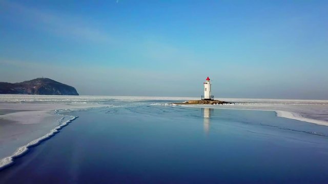 Aerial winter view of the Tokarevskiy lighthouse - one of the oldest lighthouses in the Far East, still an important navigational structure and popular attractions of Vladivostok city, Russia.