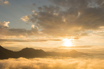 beautiful sunrise over mountain with fog 