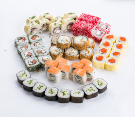 Sushi set and composition at white background. Japanese food restaurant, sushi maki gunkan roll plate or platter set.
