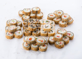 Sushi set and composition at white background. Japanese food restaurant, sushi maki gunkan roll plate or platter set.