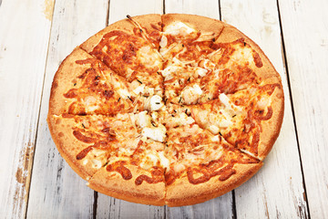 Delicious fresh pizza with seafood on wooden table.     